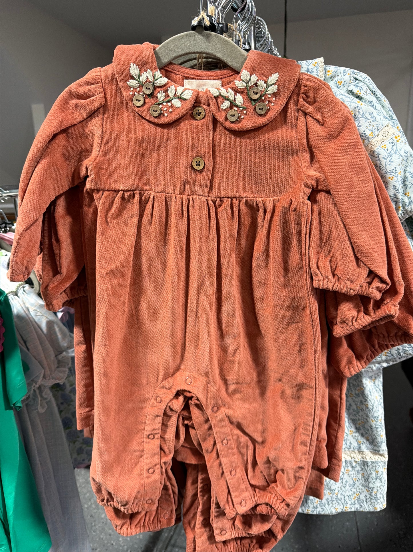 Rust corduroy romper with embroidered detail